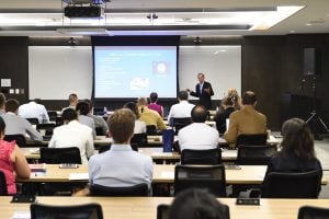 image of presenter in a classroom speaking to event attendees