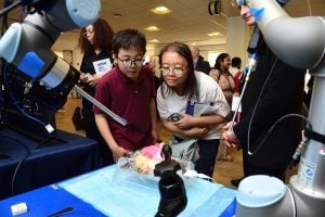 Researchers and attendees observing demo of JHU research 