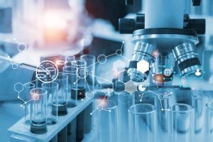 Drawings depicting a web of ideas and data have been placed over a photo of a microscope and test tubes.