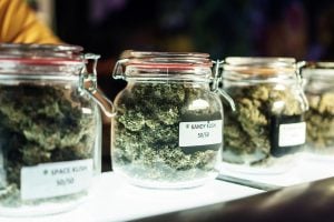 A dispensary worker vending jars of cannabis.